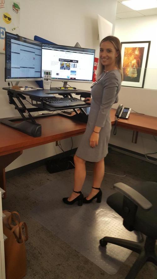 Woman standing in front of her standing desk