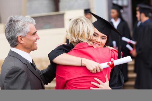 Graduate student hugging her parents